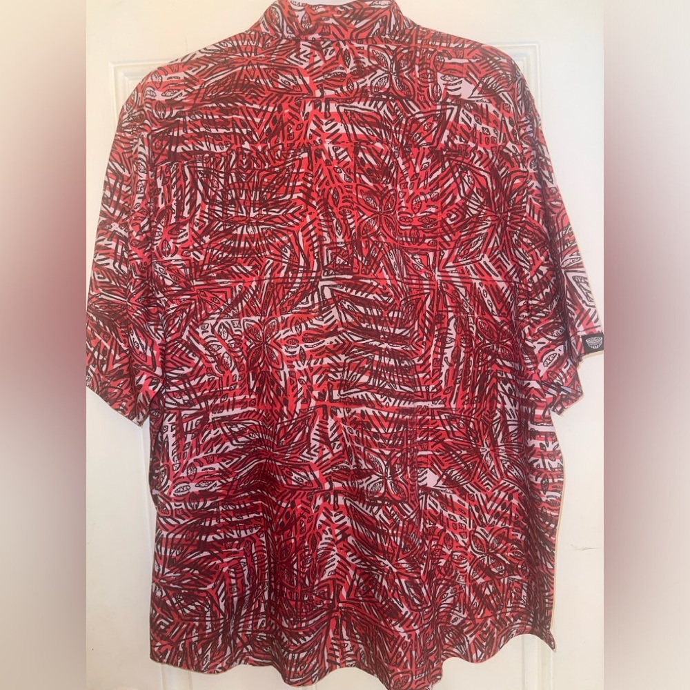 Striking Tanoa Aloha shirt, vibrant red tribal print, made in Guam.